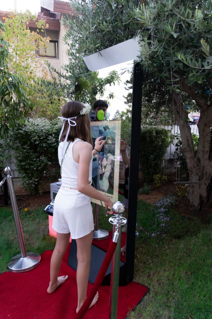 Teenager interacting with a photo booth